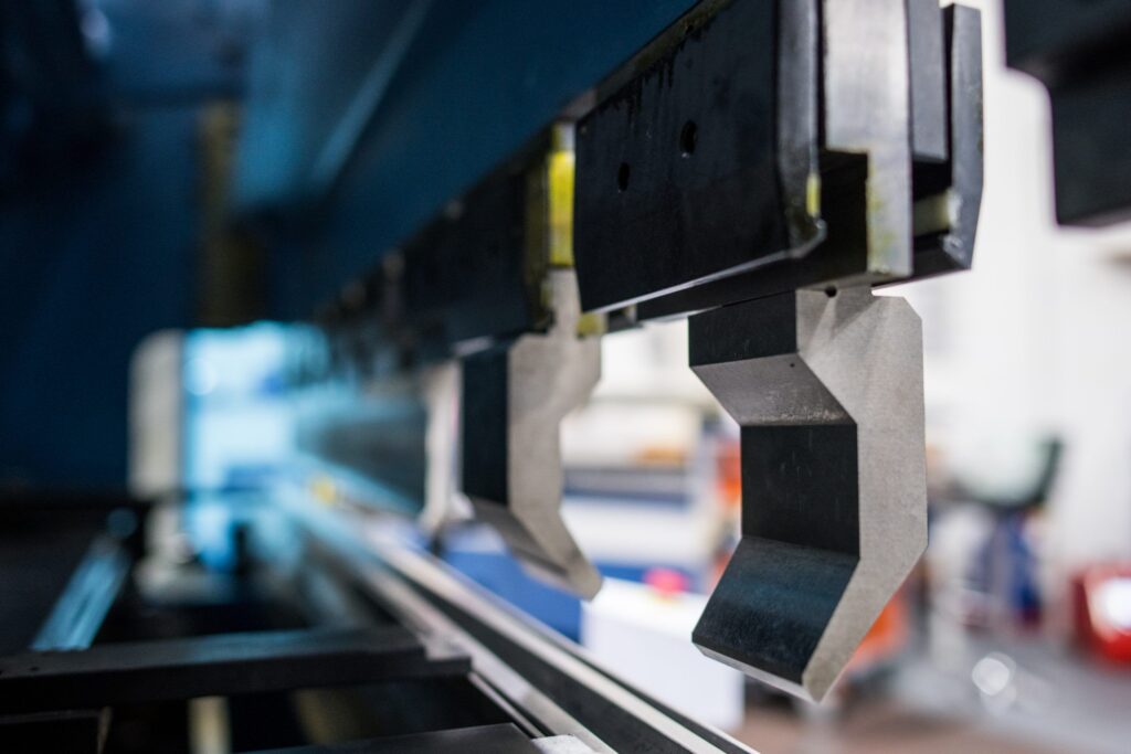 Segmented press brake punch tools mounted on the upper beam, designed for precise and repeatable sheet metal bending. The modular tooling enables flexible configurations for complex profiles and efficient setup changes.